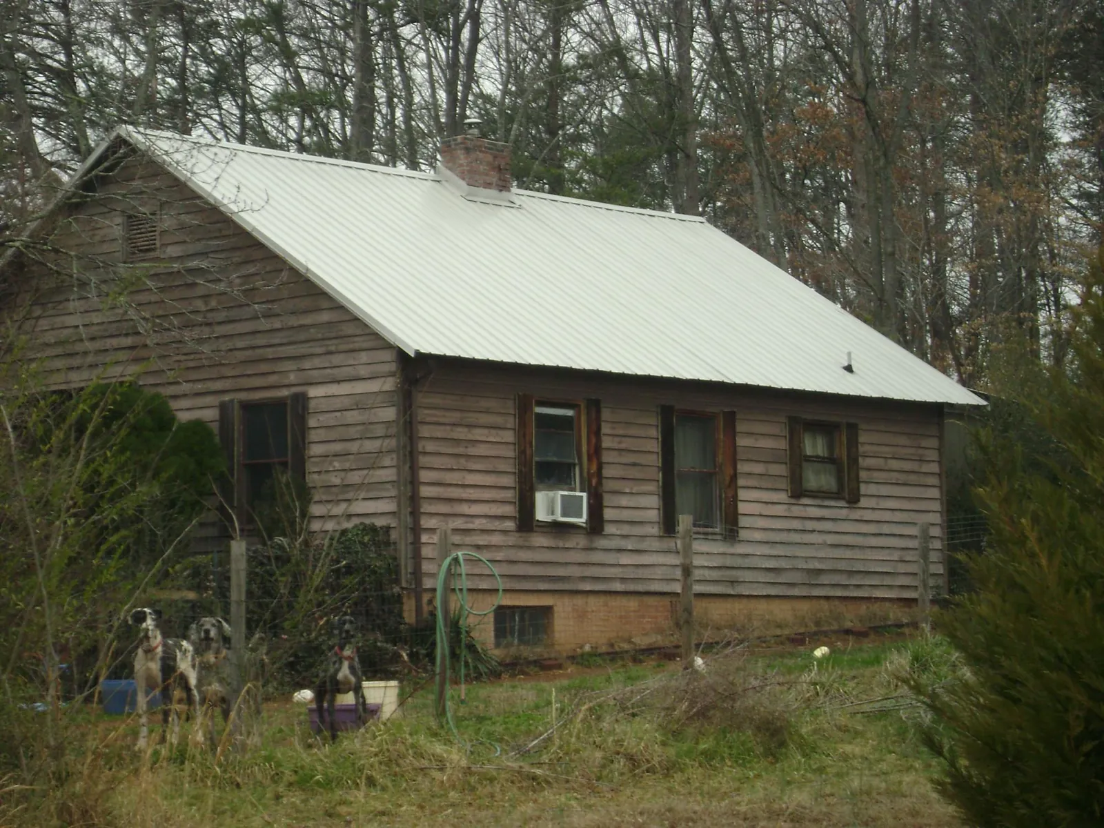 White metal roof on an old wood sided farmhouse, from a Metal Roof Installation job in Adel